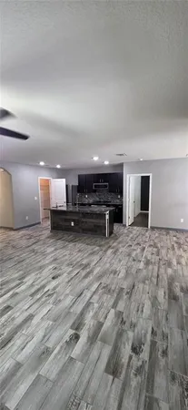 a view of a room with wooden floor