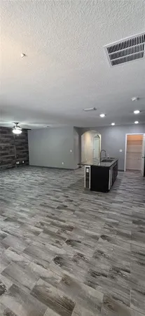 a kitchen with stainless steel appliances granite countertop a refrigerator and a stove