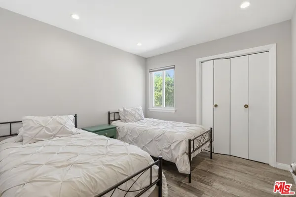 a bedroom with two beds and a window