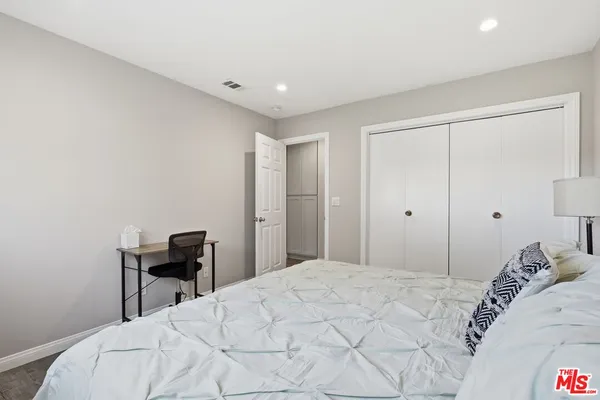 a bedroom with a bed and a table in it