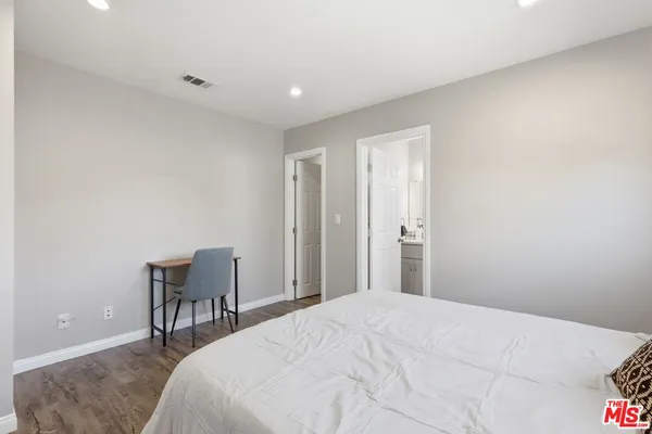 a bedroom with a bed and a desk