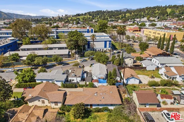 an aerial view of residential houses with outdoor space