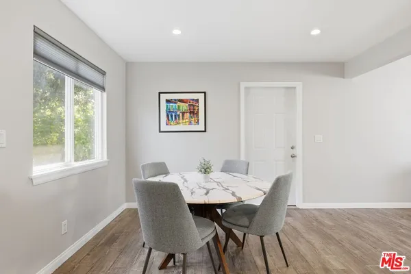 a view of a dining room with furniture and wooden floor