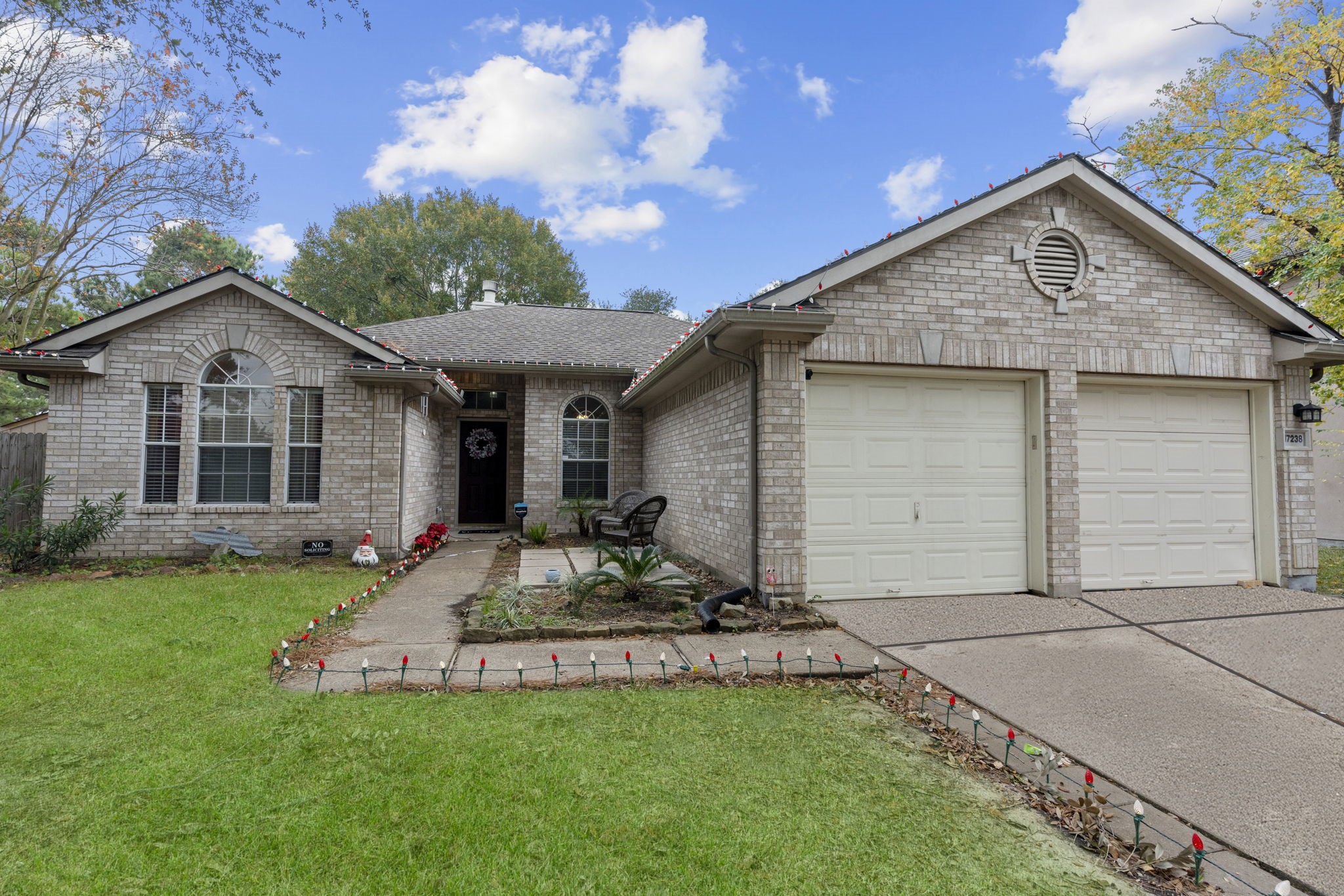 17238 Stonebridge Trail Houston, TX 77095 - Photo 1 of 25 a front view of a house with a garden and outdoor seating