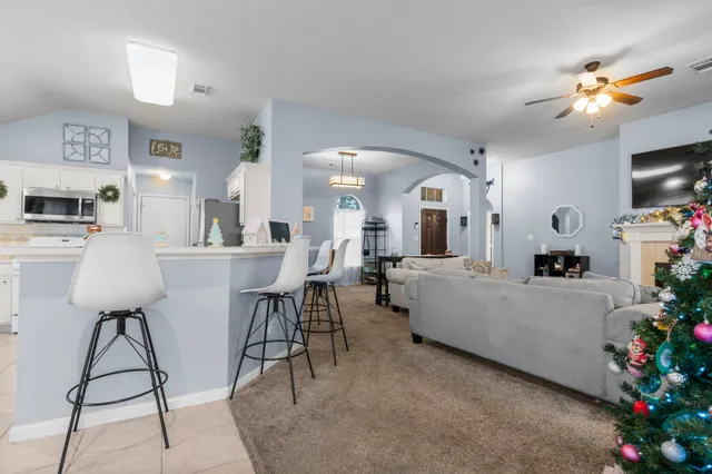 a living room with furniture and flowers