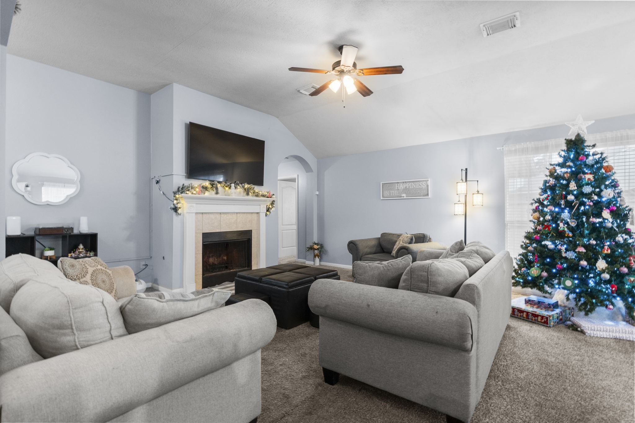 17238 Stonebridge Trail Houston, TX 77095 - Photo 15 of 25 a living room with furniture a chandelier and a fireplace