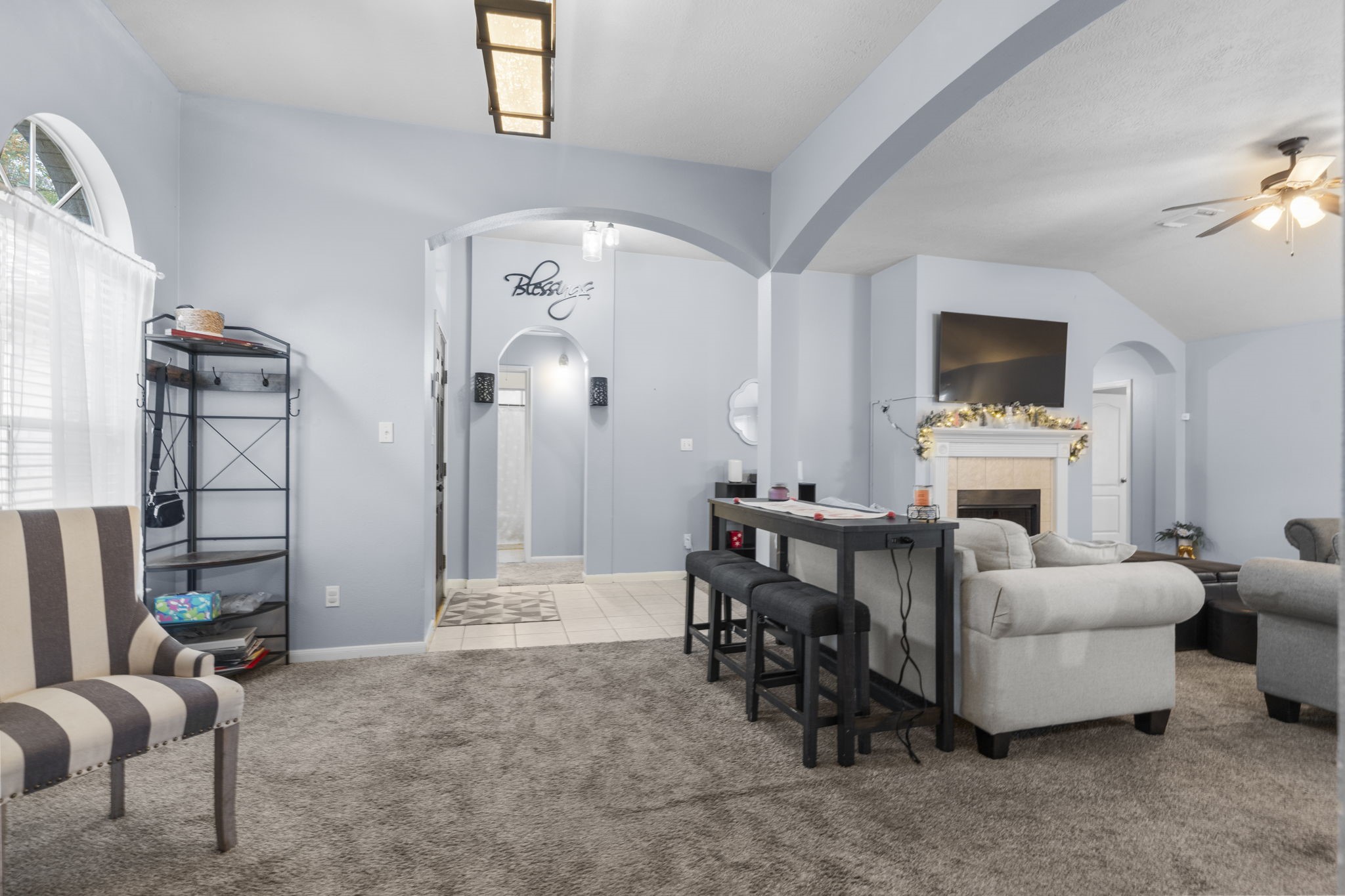 17238 Stonebridge Trail Houston, TX 77095 - Photo 5 of 25 a living room with furniture a fireplace and a flat screen tv