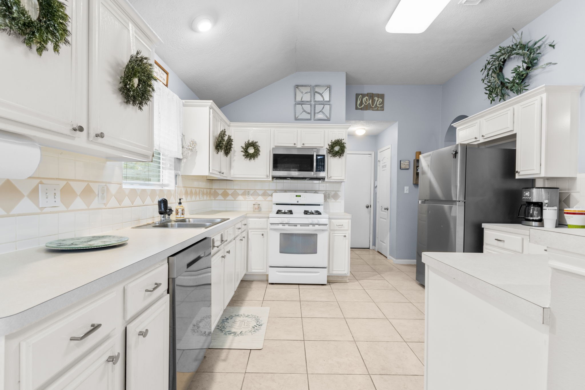 17238 Stonebridge Trail Houston, TX 77095 - Photo 10 of 25 a kitchen with a stove a sink and a refrigerator