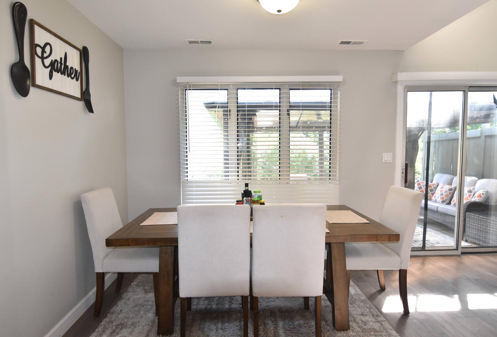 8301 High Point Circle, Unit C Darien, IL 60561 - Photo 17 of 35 a view of a dining room with furniture and a potted plant