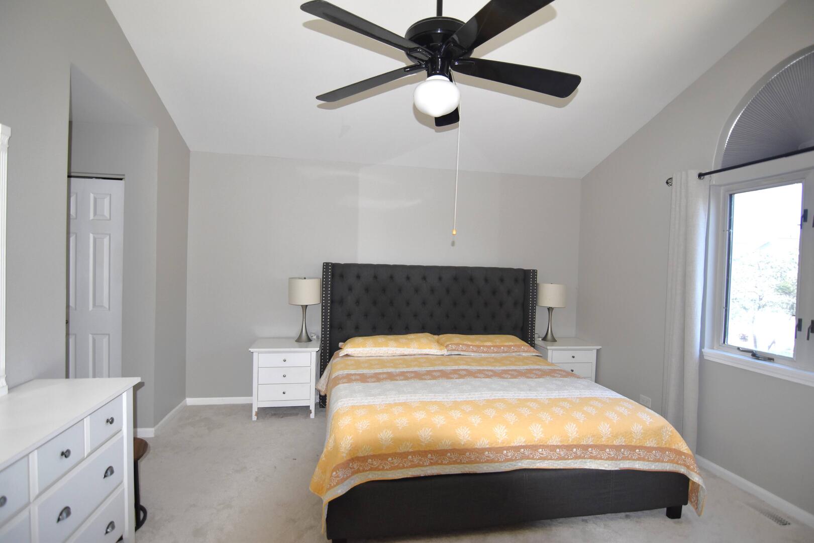 8301 High Point Circle, Unit C Darien, IL 60561 - Photo 25 of 35 a bed sitting in a bedroom next to a window