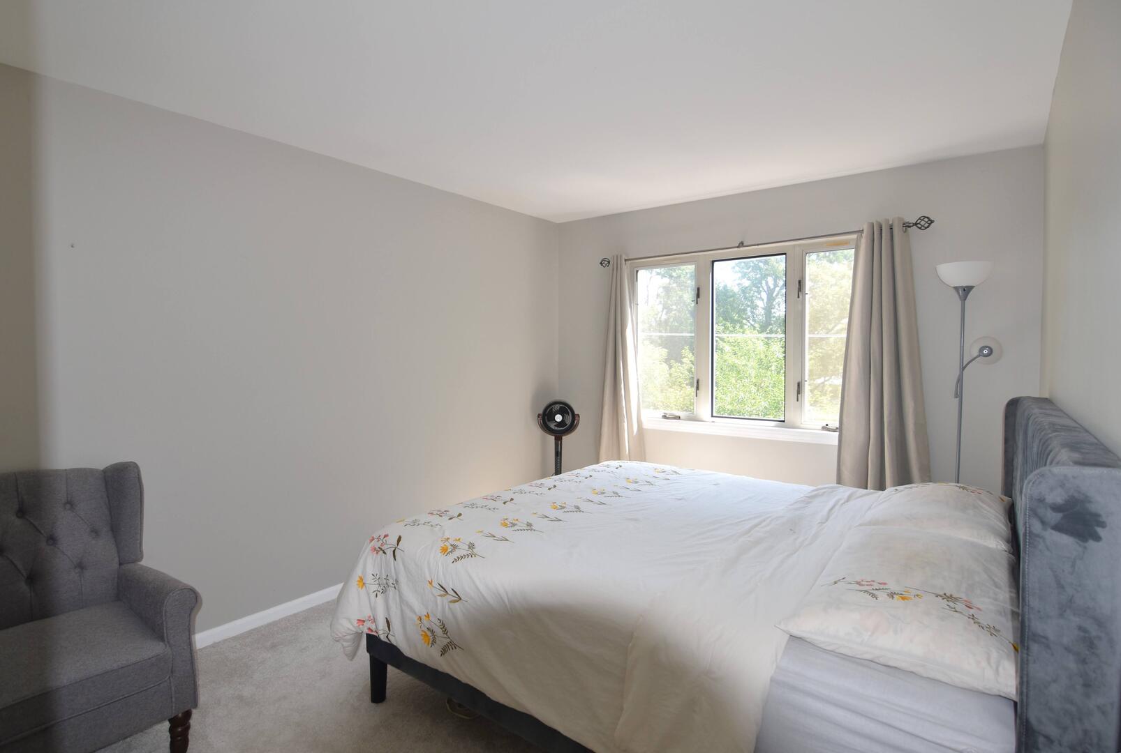 8301 High Point Circle, Unit C Darien, IL 60561 - Photo 27 of 35 a bedroom with a bed and a couch with window