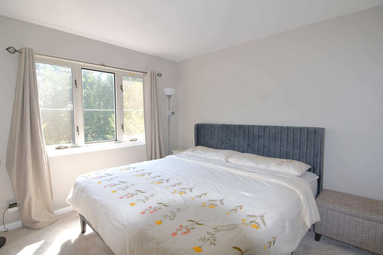 8301 High Point Circle, Unit C Darien, IL 60561 - Photo 30 of 35 a large bed sitting in a bedroom next to a window