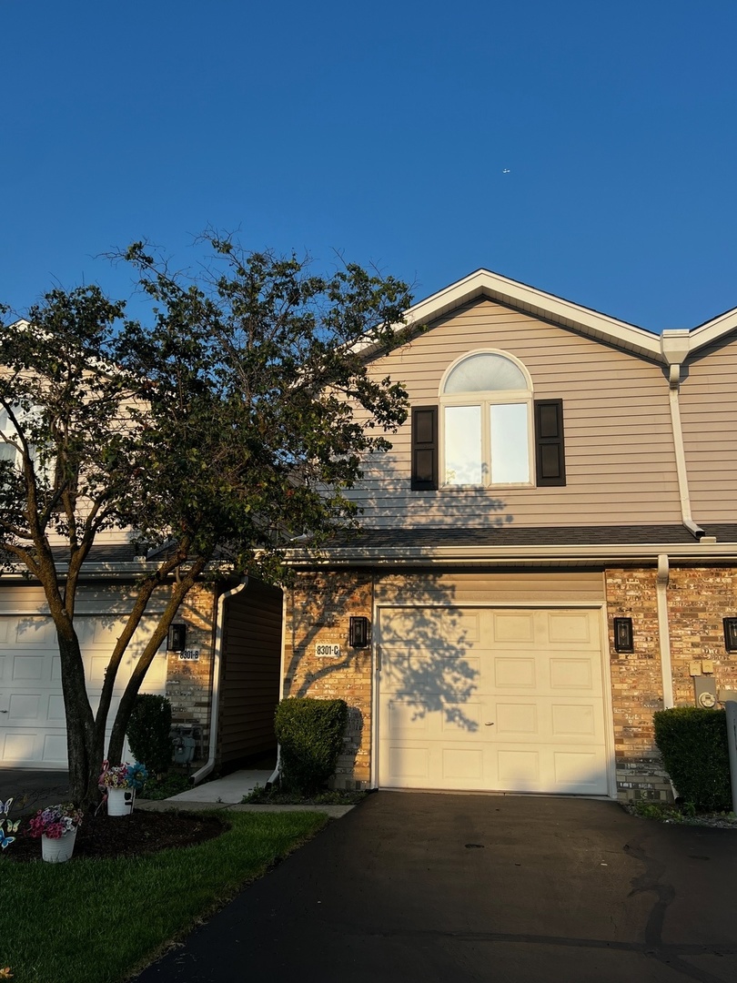 8301 High Point Circle, Unit C Darien, IL 60561 - Photo 3 of 35 a front view of a house with a yard