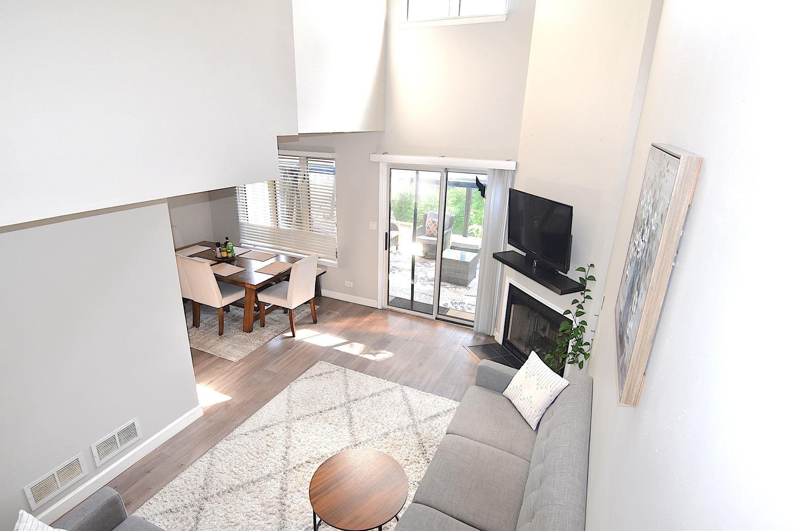 8301 High Point Circle, Unit C Darien, IL 60561 - Photo 6 of 35 a living room with furniture a flat screen tv and a fireplace