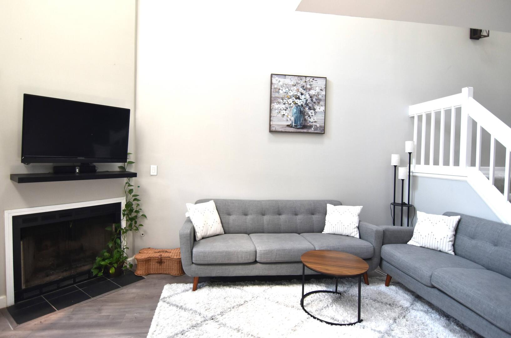 8301 High Point Circle, Unit C Darien, IL 60561 - Photo 7 of 35 a living room with furniture a flat screen tv and a fireplace