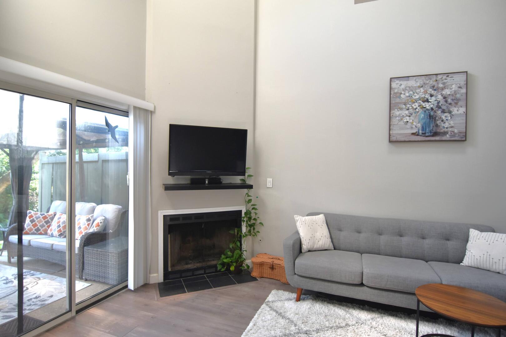 8301 High Point Circle, Unit C Darien, IL 60561 - Photo 8 of 35 a living room with furniture a flat screen tv and a fireplace