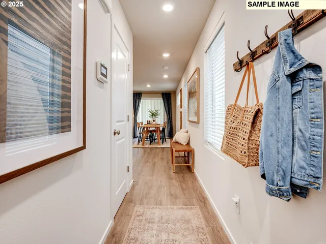 a view of hallway with furniture and a window