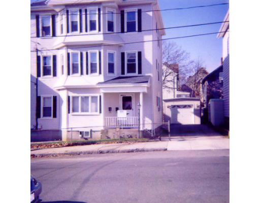 a front view of a building with a yard