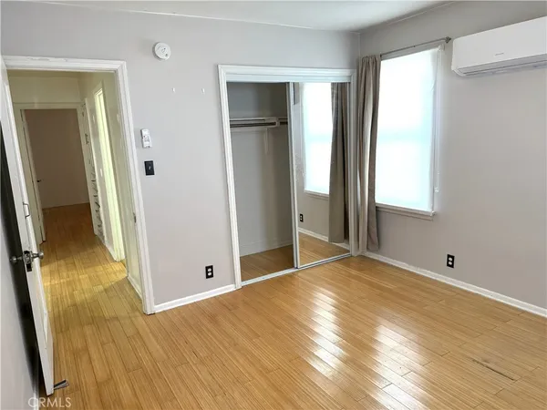 an empty room with wooden floor and a window