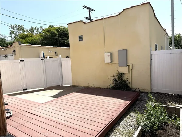 a wooden bench sitting in front of a building