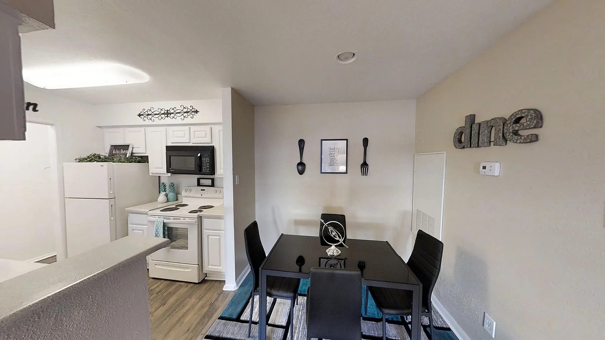 8455 Will Clayton Parkway, Unit 103 Humble, TX 77338 - Photo 22 of 23 a view of a dining room with furniture and wooden floor