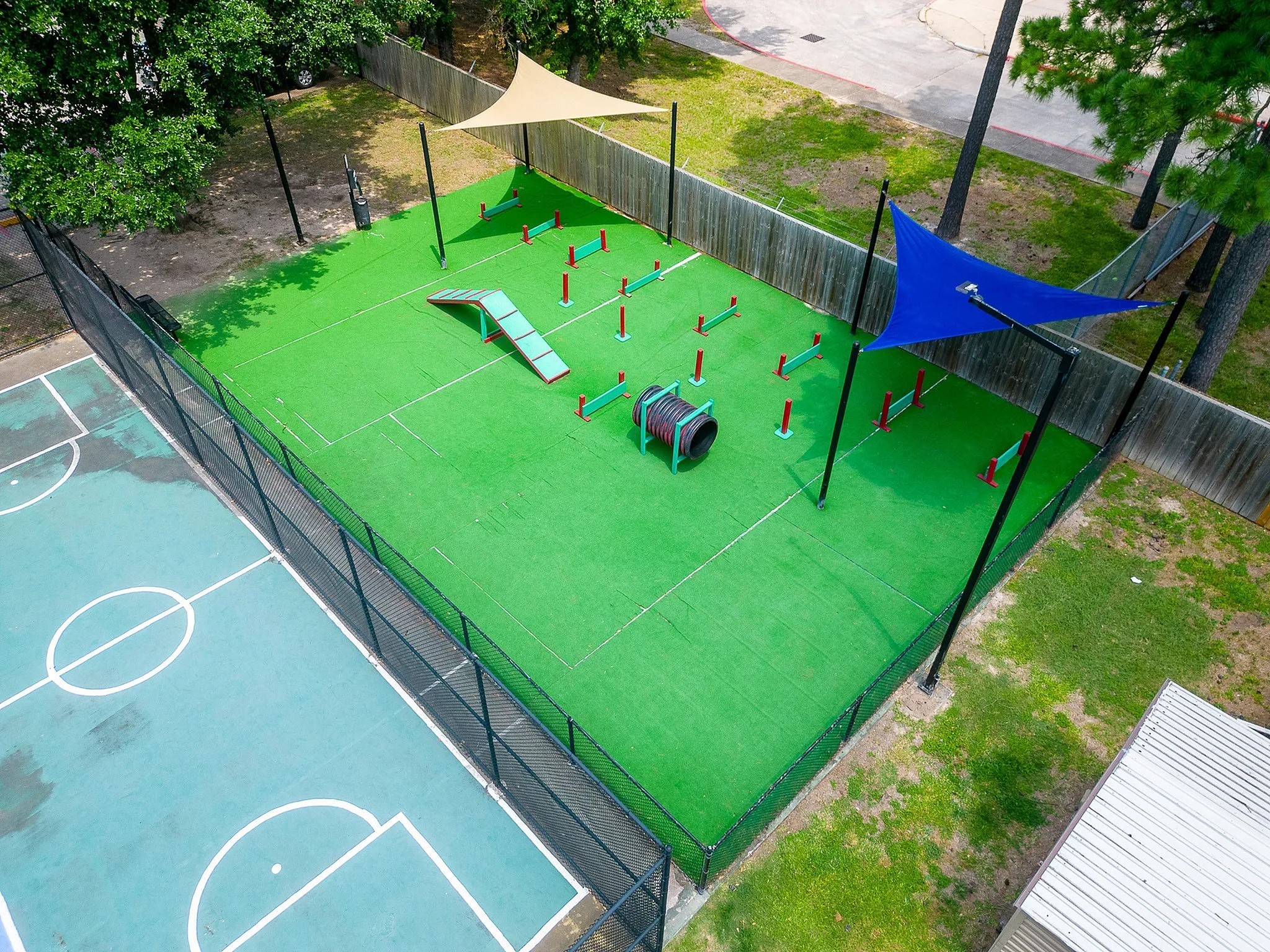 8455 Will Clayton Parkway, Unit 103 Humble, TX 77338 - Photo 4 of 23 a green field with lots of trees in the background