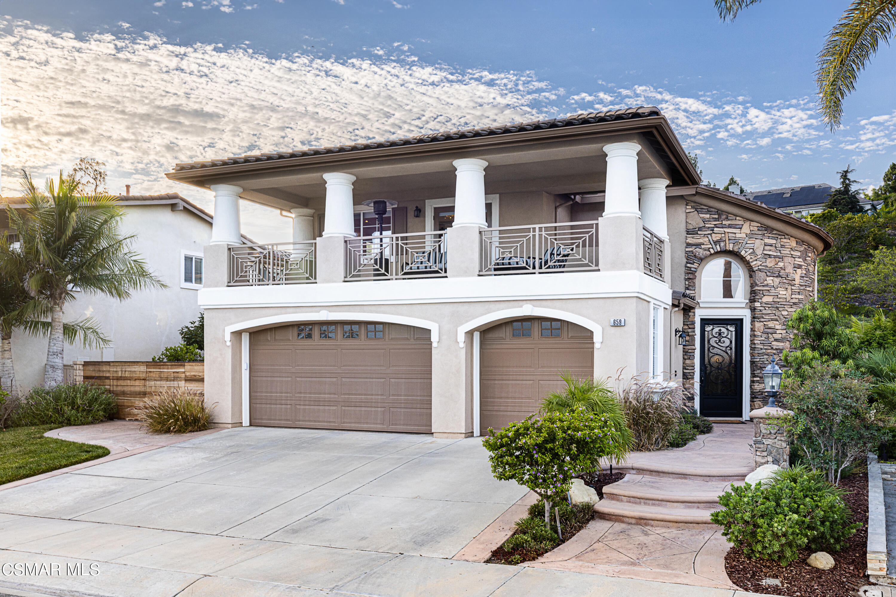 a front view of a house with a garden