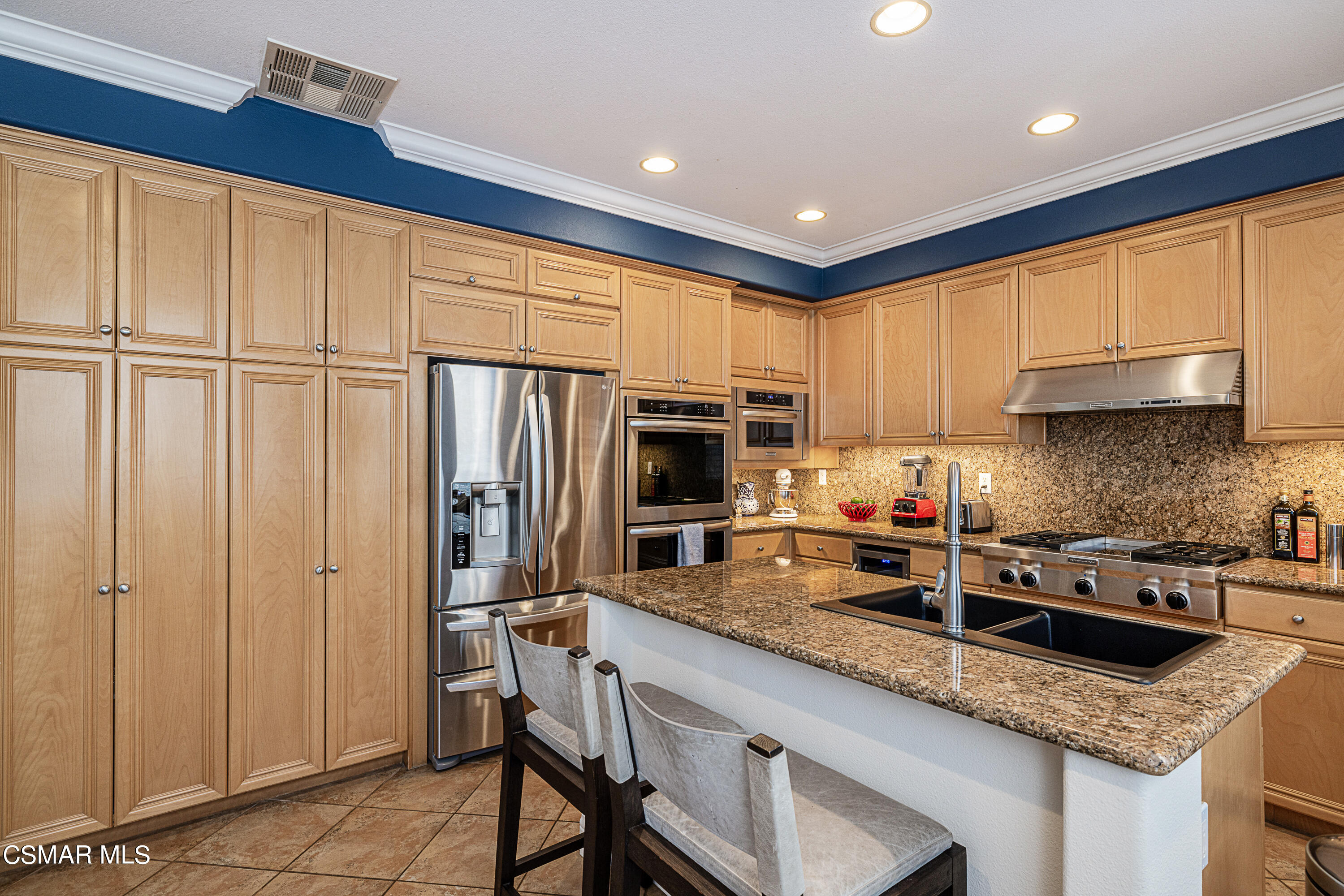 659 Corte Estrella Camarillo, CA 93010 - Photo 9 of 36 a kitchen with stainless steel appliances granite countertop a refrigerator sink and cabinets