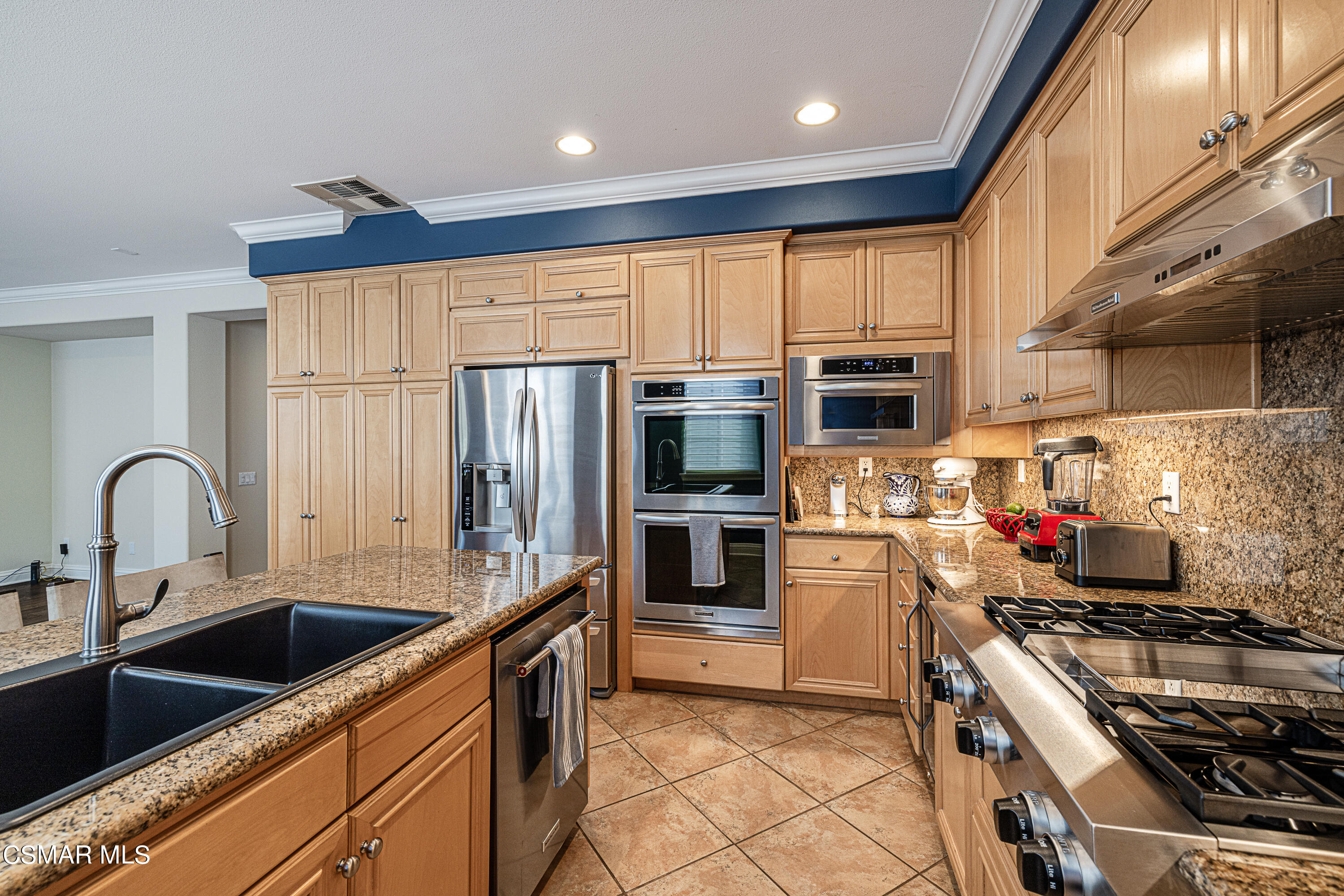 659 Corte Estrella Camarillo, CA 93010 - Photo 10 of 36 a kitchen with a stove a sink and a refrigerator
