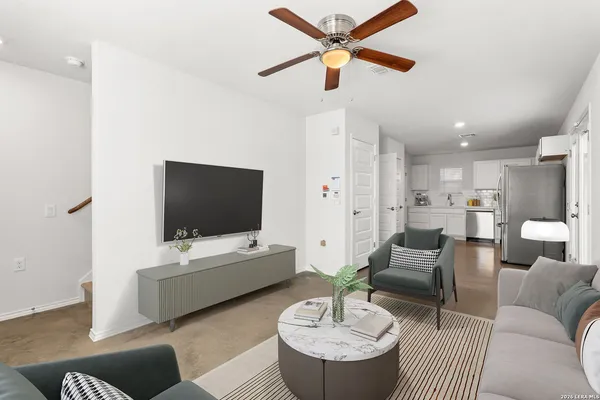 an empty room with ceiling fan and window
