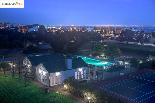 a view of a house with swimming pool and sitting area
