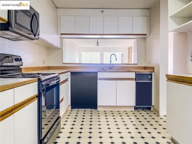 a kitchen with stainless steel appliances a sink and a stove