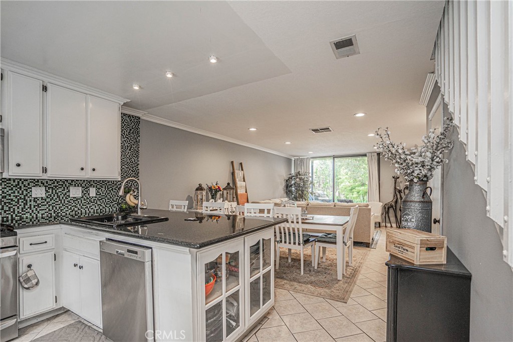 4140 Workman Mill Road, Unit 267 Whittier, CA 90601 - Photo 1 of 1 a kitchen with a sink stove and cabinets