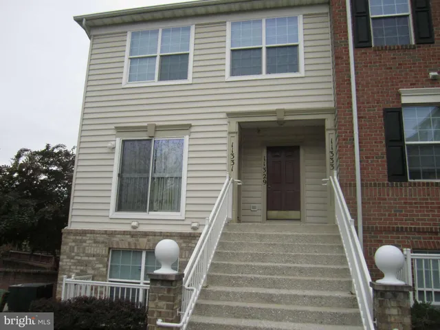 a front view of a house with entryway and stairs