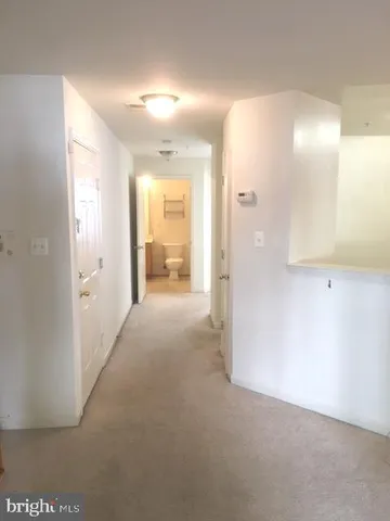 a view of a hallway with wooden shelves