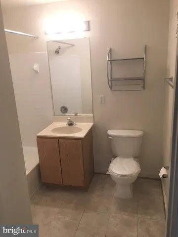 a white toilet sitting next to a bathroom sink