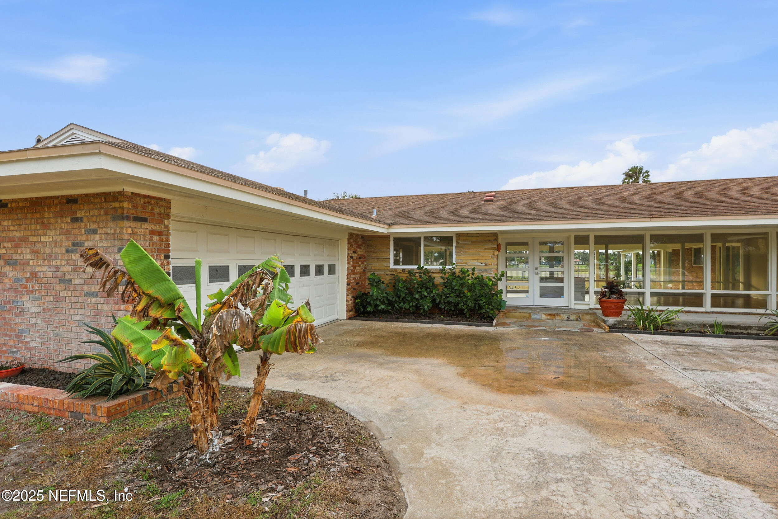 a front view of a house with a yard and outdoor seating