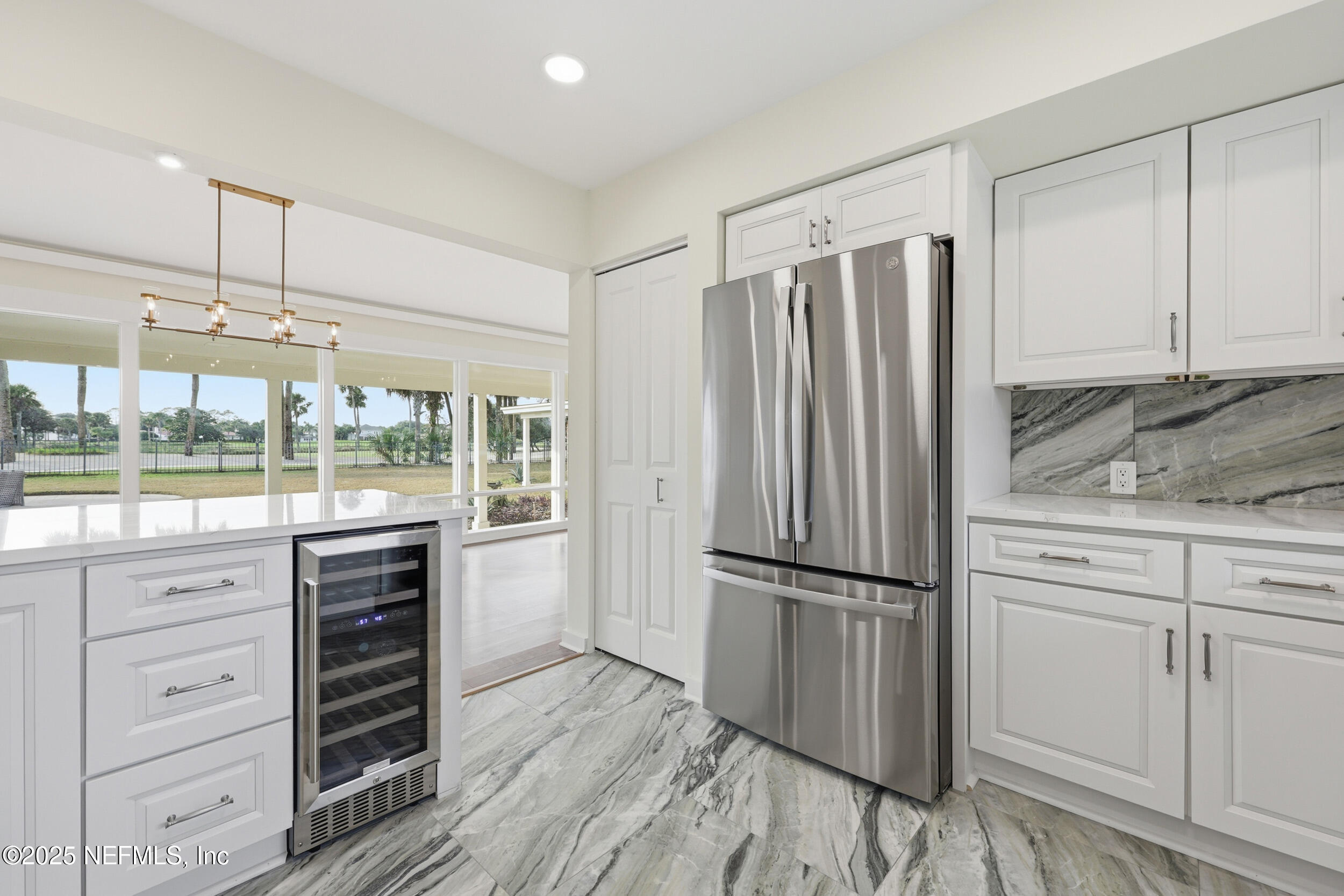 330 San Juan Drive Ponte Vedra Beach, FL 32082 - Photo 15 of 32 a kitchen with granite countertop a refrigerator and white cabinets