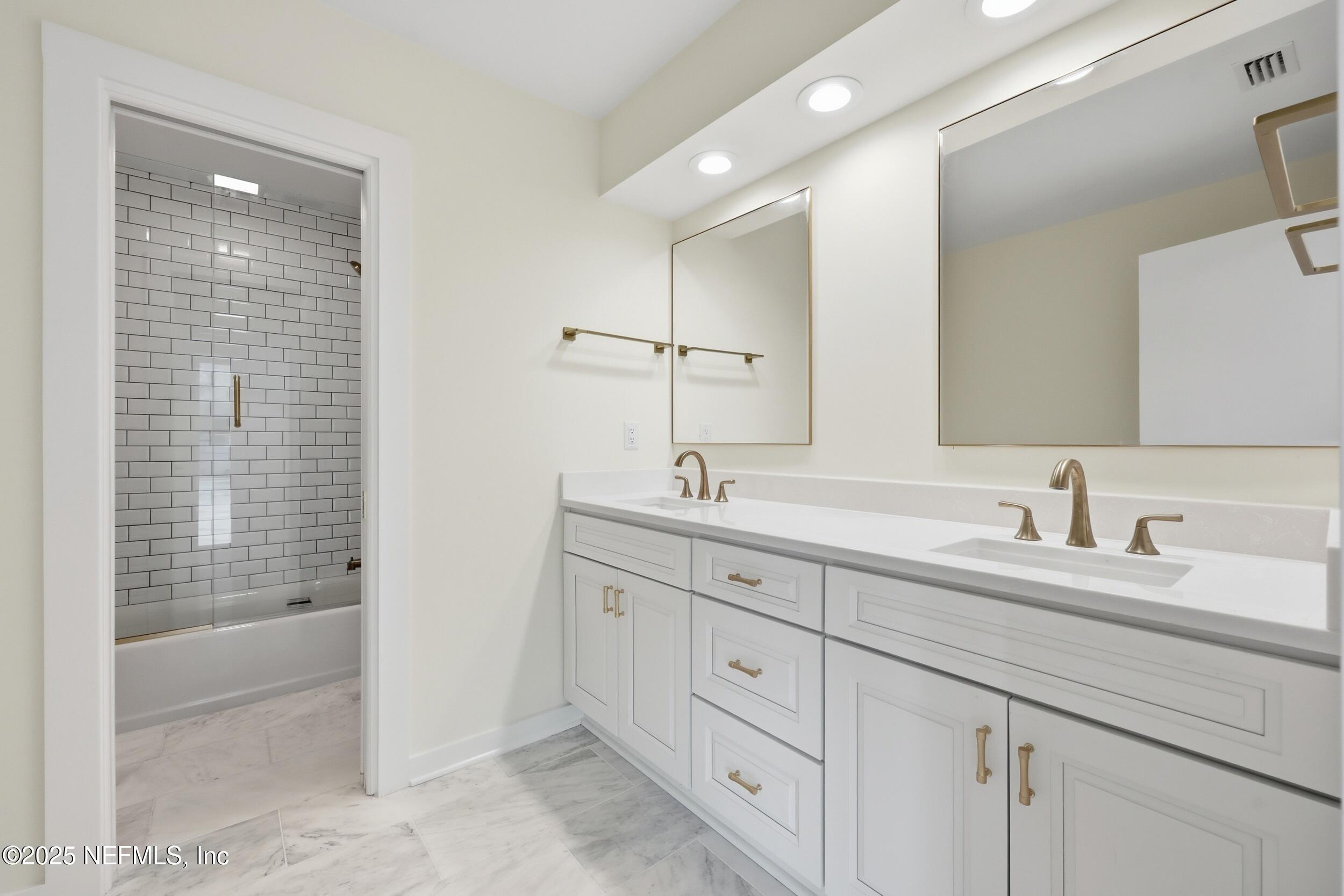 330 San Juan Drive Ponte Vedra Beach, FL 32082 - Photo 19 of 32 a bathroom with double sink and a mirror