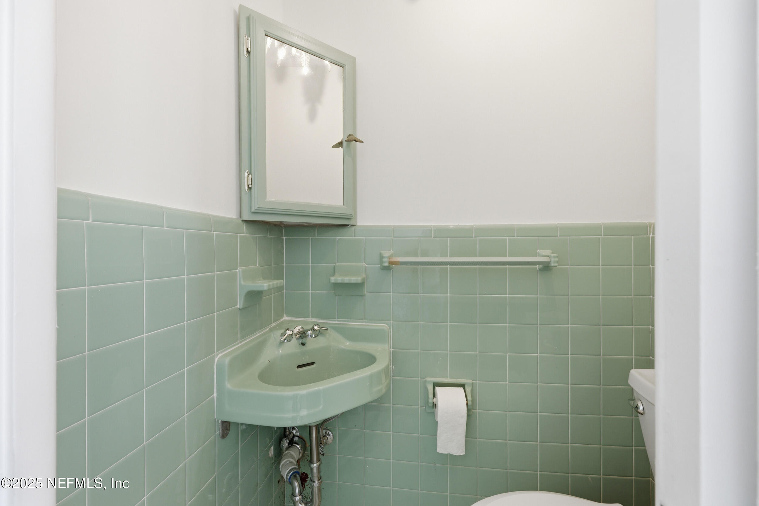 330 San Juan Drive Ponte Vedra Beach, FL 32082 - Photo 23 of 32 a bathroom with a sink a mirror and a shower