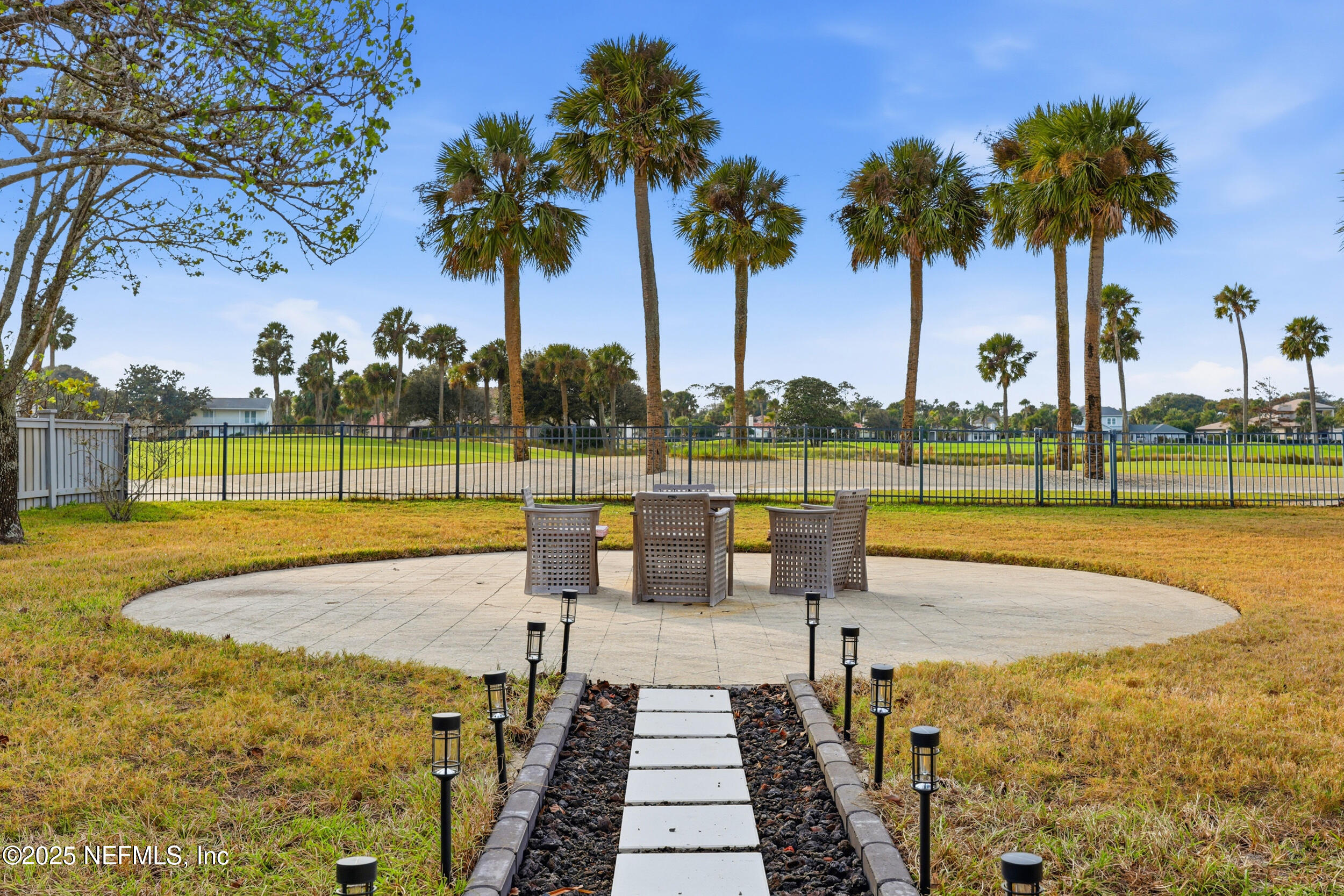 330 San Juan Drive Ponte Vedra Beach, FL 32082 - Photo 26 of 32 a view of a swimming pool with a garden and palm trees