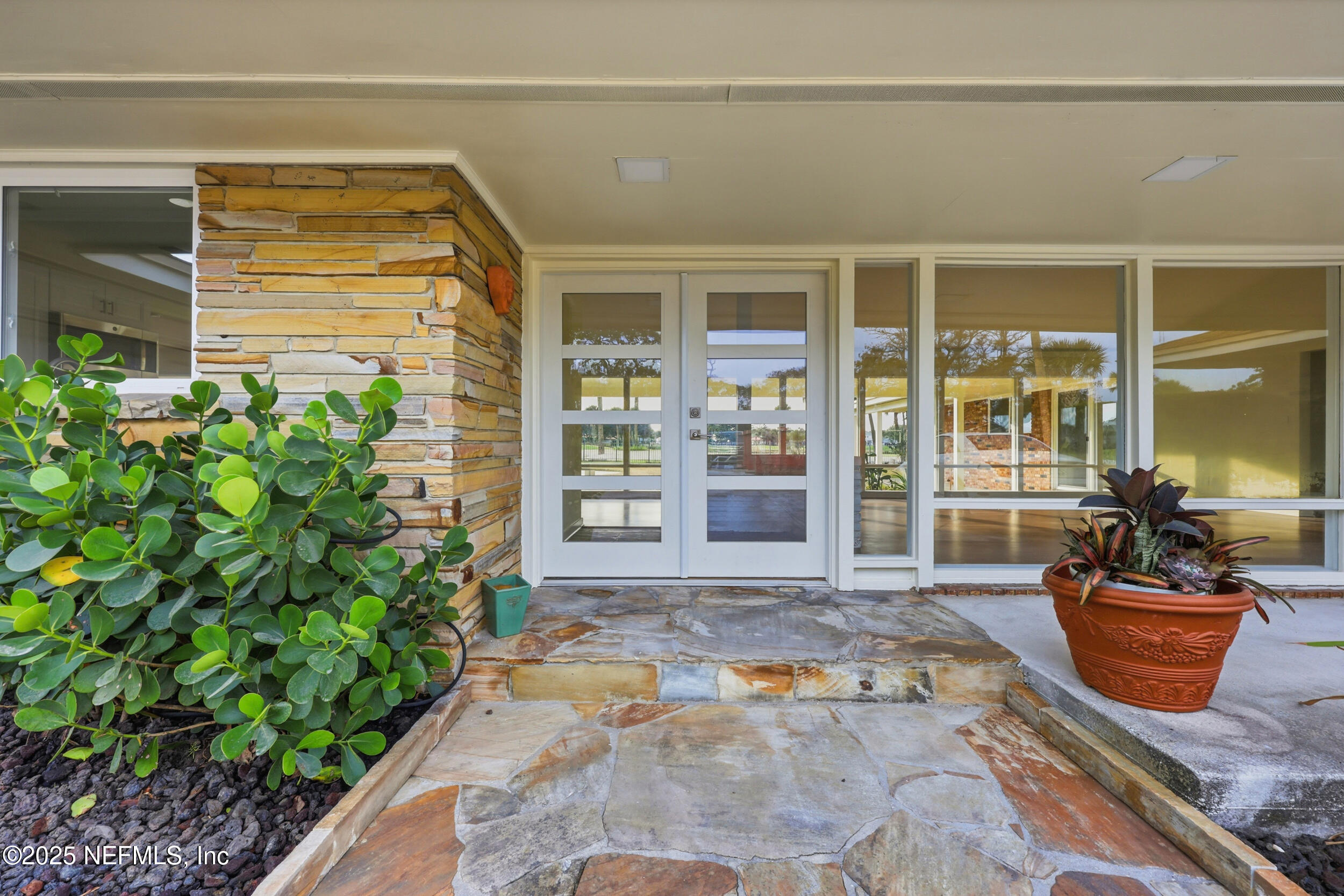 330 San Juan Drive Ponte Vedra Beach, FL 32082 - Photo 3 of 32 a view of a brick house with potted plants