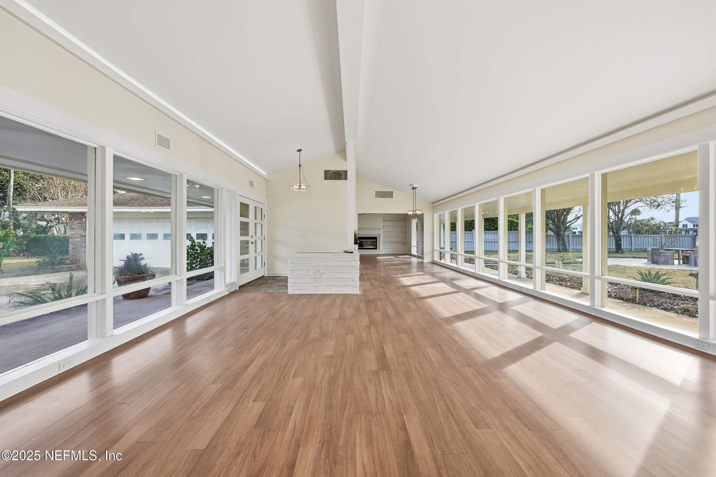 330 San Juan Drive Ponte Vedra Beach, FL 32082 - Photo 7 of 32 a view of empty room with wooden floor and floor to ceiling window