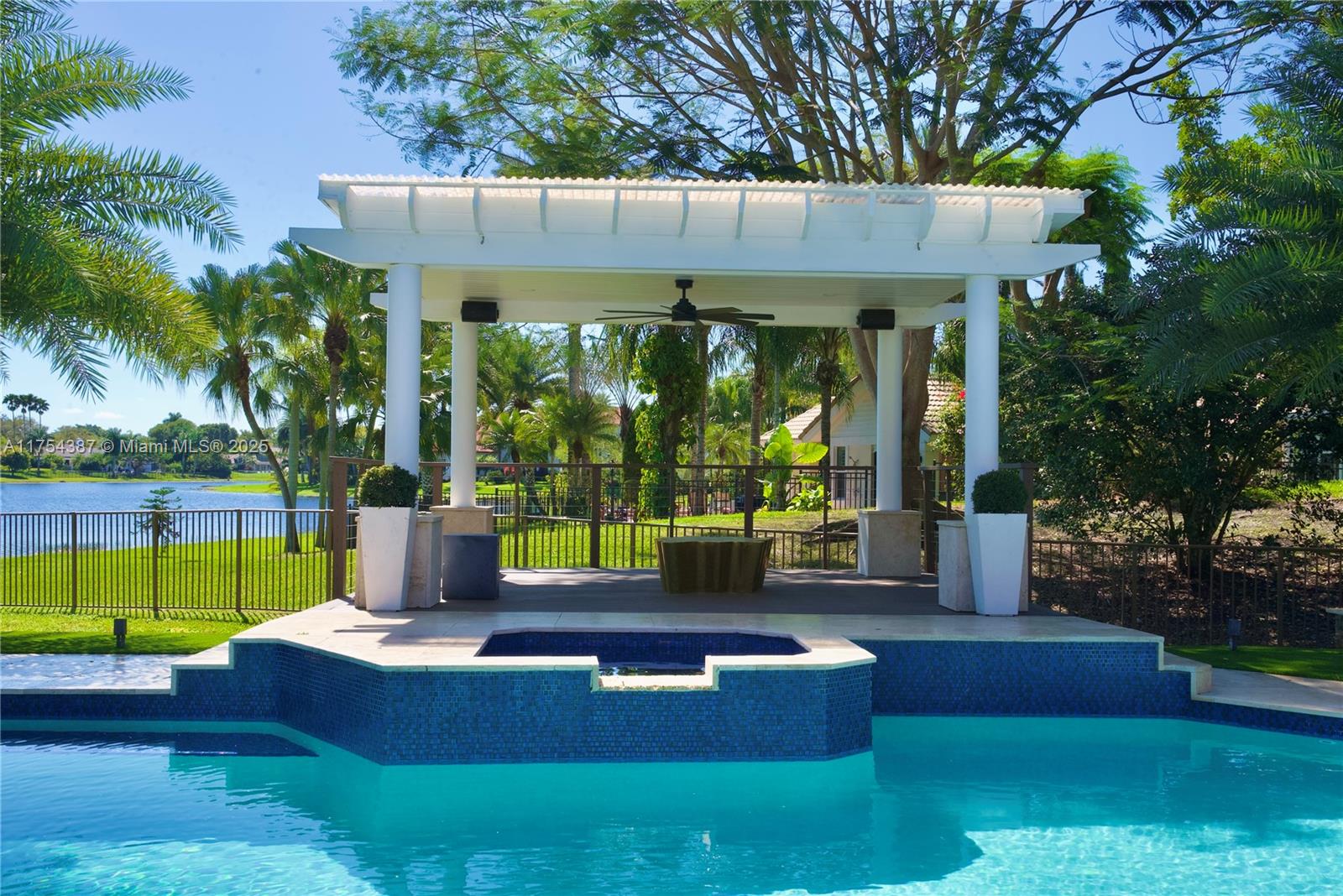 2980 Windmill Ranch Road Weston, FL 33331 - Photo 29 of 31 a view of a house with a backyard patio and swimming pool