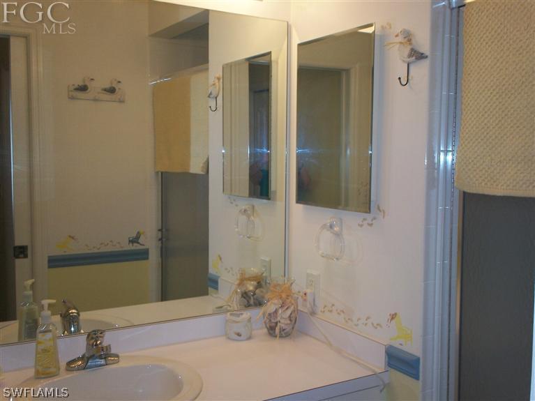 14111 Brant Point Circle, Unit 236 Fort Myers, FL 33919 - Photo 13 of 22 a bathroom with a sink and a mirror