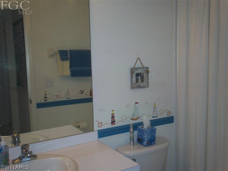 14111 Brant Point Circle, Unit 236 Fort Myers, FL 33919 - Photo 17 of 22 a bathroom with a sink and a mirror