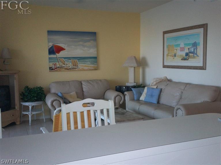 14111 Brant Point Circle, Unit 236 Fort Myers, FL 33919 - Photo 18 of 22 a living room with furniture and a painting on the wall