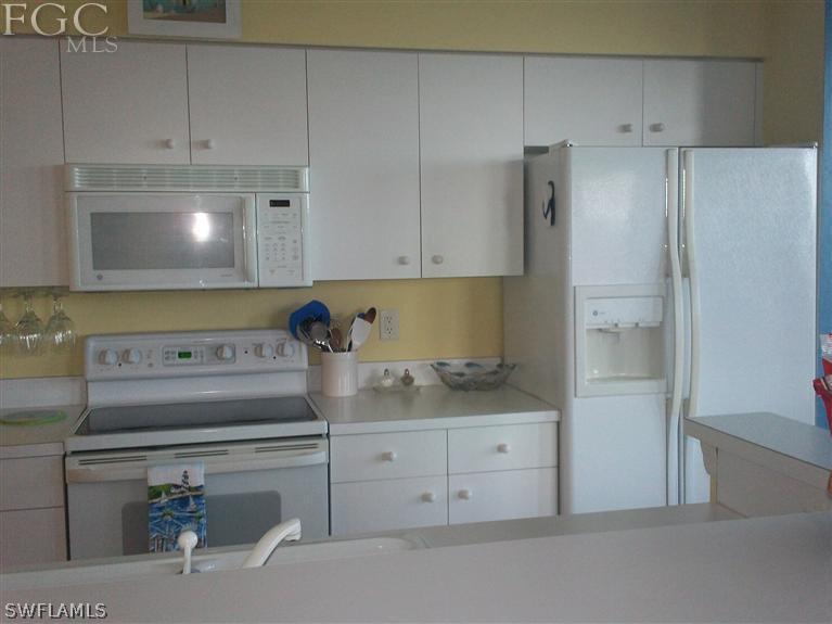 14111 Brant Point Circle, Unit 236 Fort Myers, FL 33919 - Photo 4 of 22 a kitchen with appliances cabinets and a counter top space