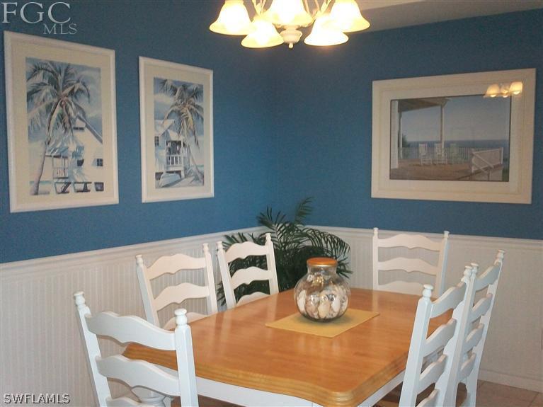 14111 Brant Point Circle, Unit 236 Fort Myers, FL 33919 - Photo 5 of 22 a view of a dining room with furniture and chandelier