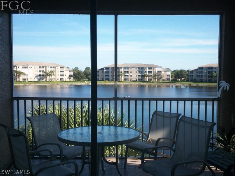 14111 Brant Point Circle, Unit 236 Fort Myers, FL 33919 - Photo 7 of 22 a view of a chairs and table on the deck